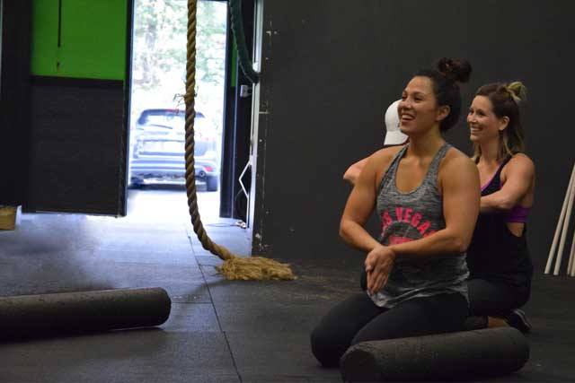 Happy group of ladies stretching after a workout