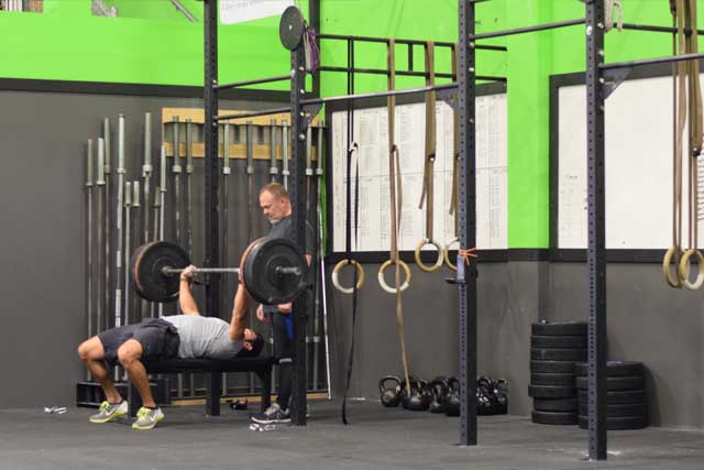 Guys doing bench presses