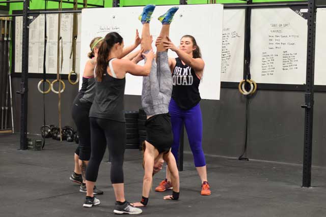 Groups of ladies practicing handstands